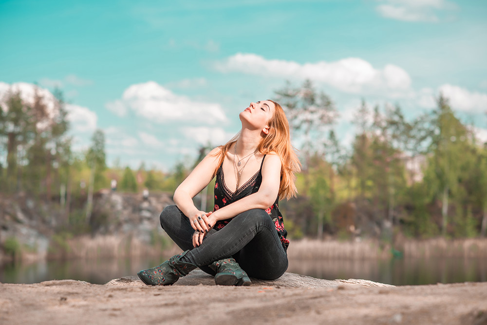 Woman relaxed sitting by water